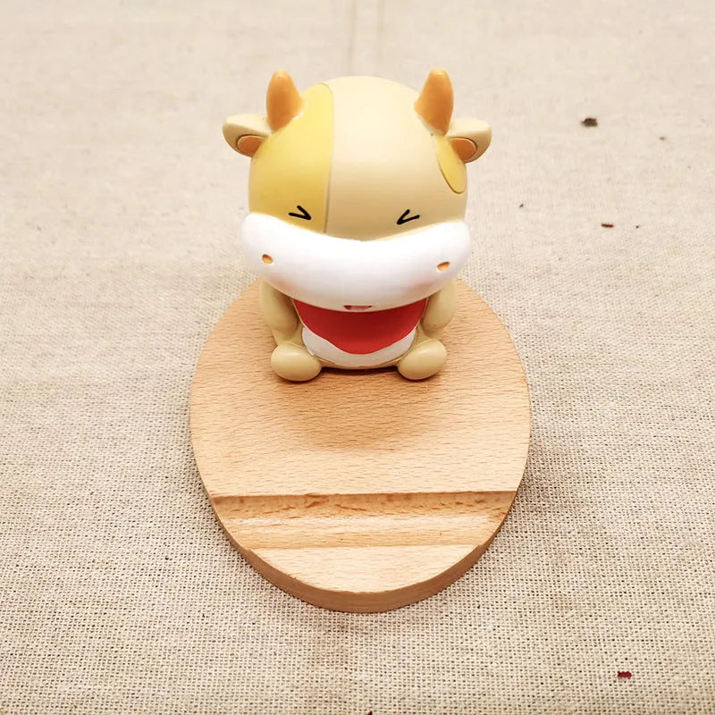 A decorative resin mobile phone stand holding a smartphone, shown in an animal design variant.