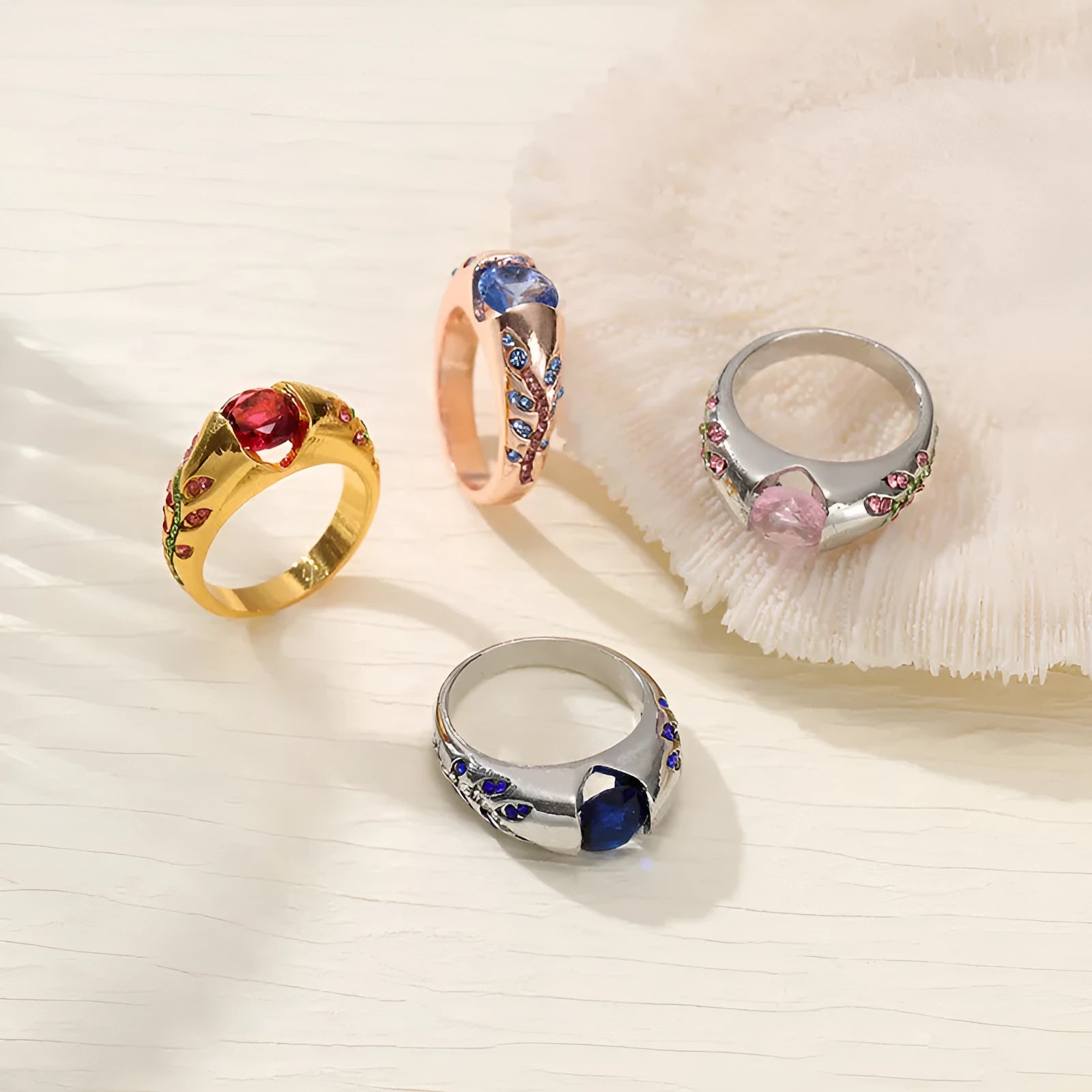 Leaf style zinc alloy ring with round zirconium inlay in gold colour on white background