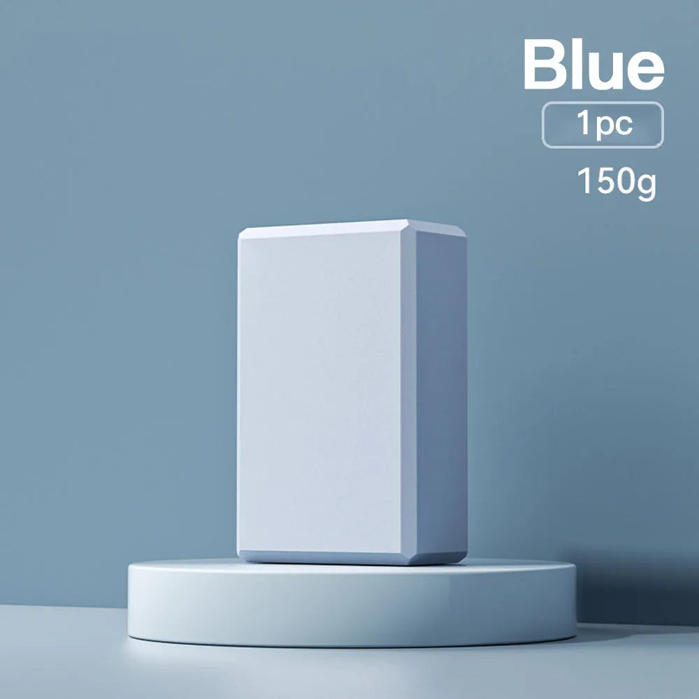 Solid colour high-density EVA yoga brick with hexagonal ridges on a gym floor.