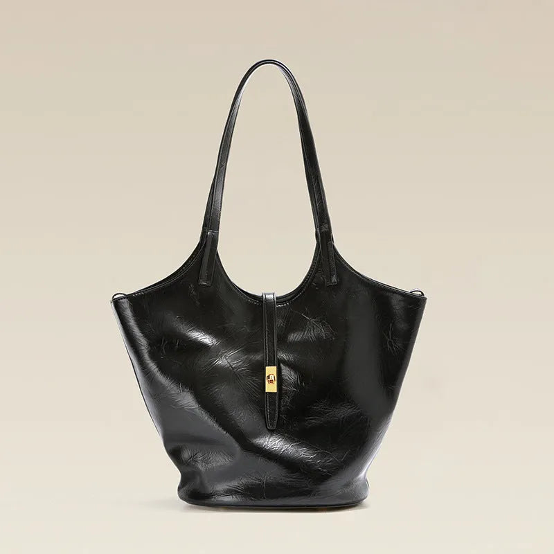 Black genuine leather large capacity bucket bag with visible stitching and crossbody strap on white background