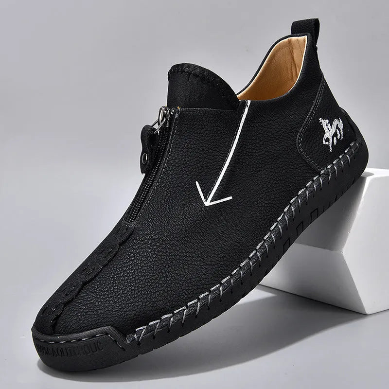 Men's black leather martin boots with a front zipper and round toe on a rubber sole.