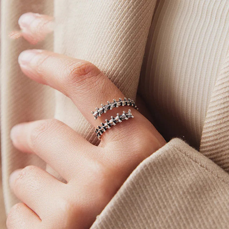 Women's silver tone adjustable backbone open ring with pumpkin skull motif on black background