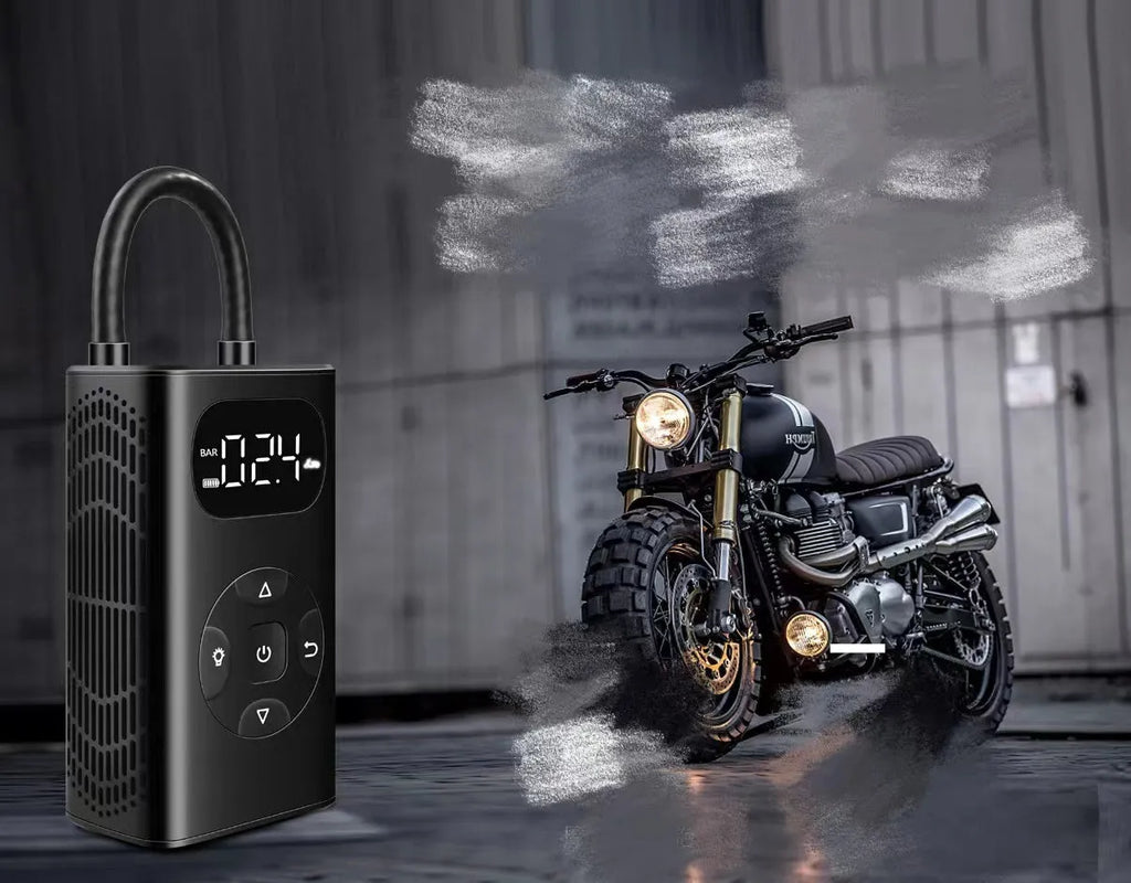 Black rectangular portable tyre inflator and power bank unit with a connected inflation hose on a table.
