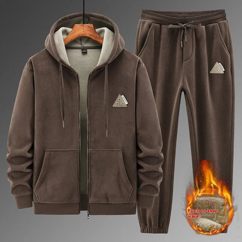 Grey hooded sweatshirt and matching trousers sports suit set laid flat