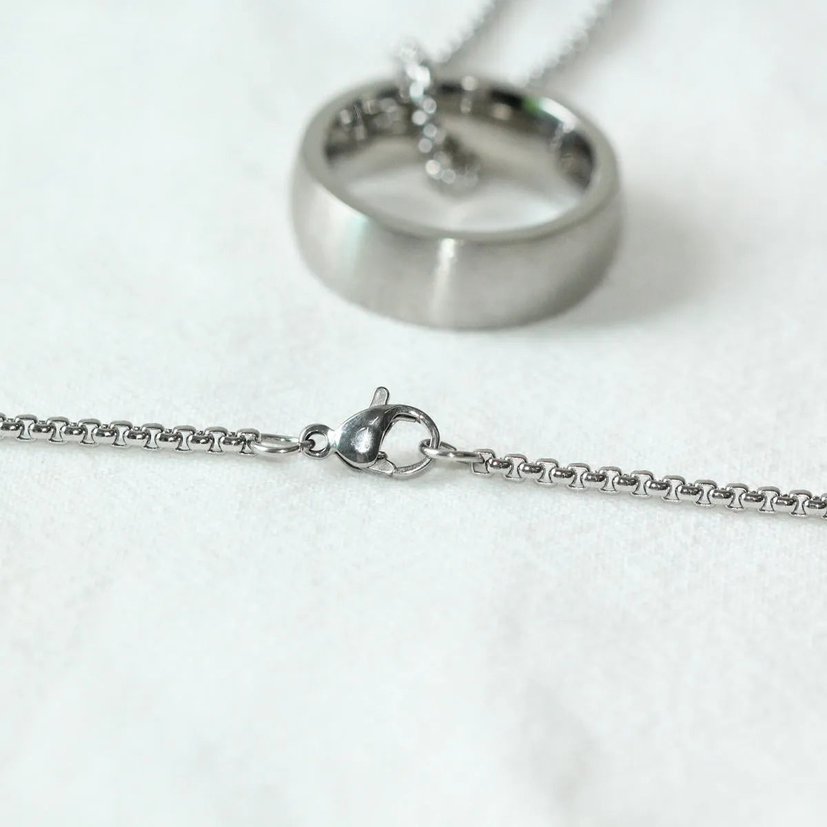 Men's silver stainless steel pearl chain necklace with titanium steel circle pendant on grey background
