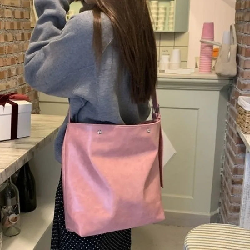 Pink corduroy one-shoulder commuter bag with dimensions 39cm by 32cm.
