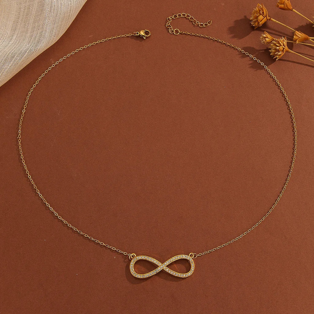 Gold plated copper infinity love pendant necklace with diamond accents and fine chain.