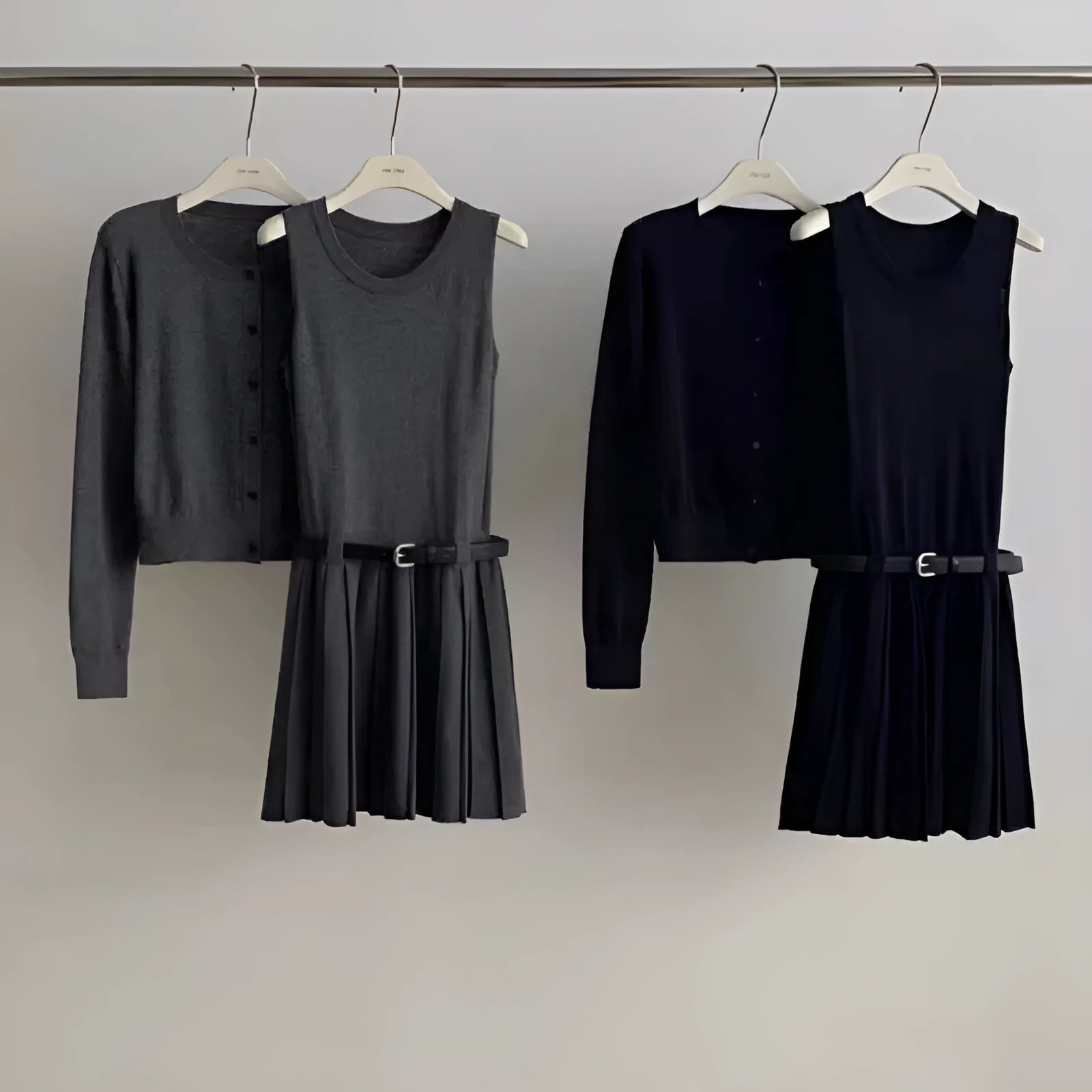 Women's grey art retro two-piece set with pleated vest skirt, adjustable belt, and long-sleeved knitted cardigan.