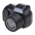 Black retro-style mini digital video camera with small screen shown on a table.