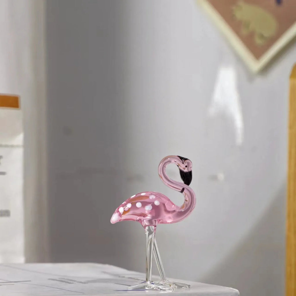 Pink crystal flamingo decorative figure on a table in modern style.