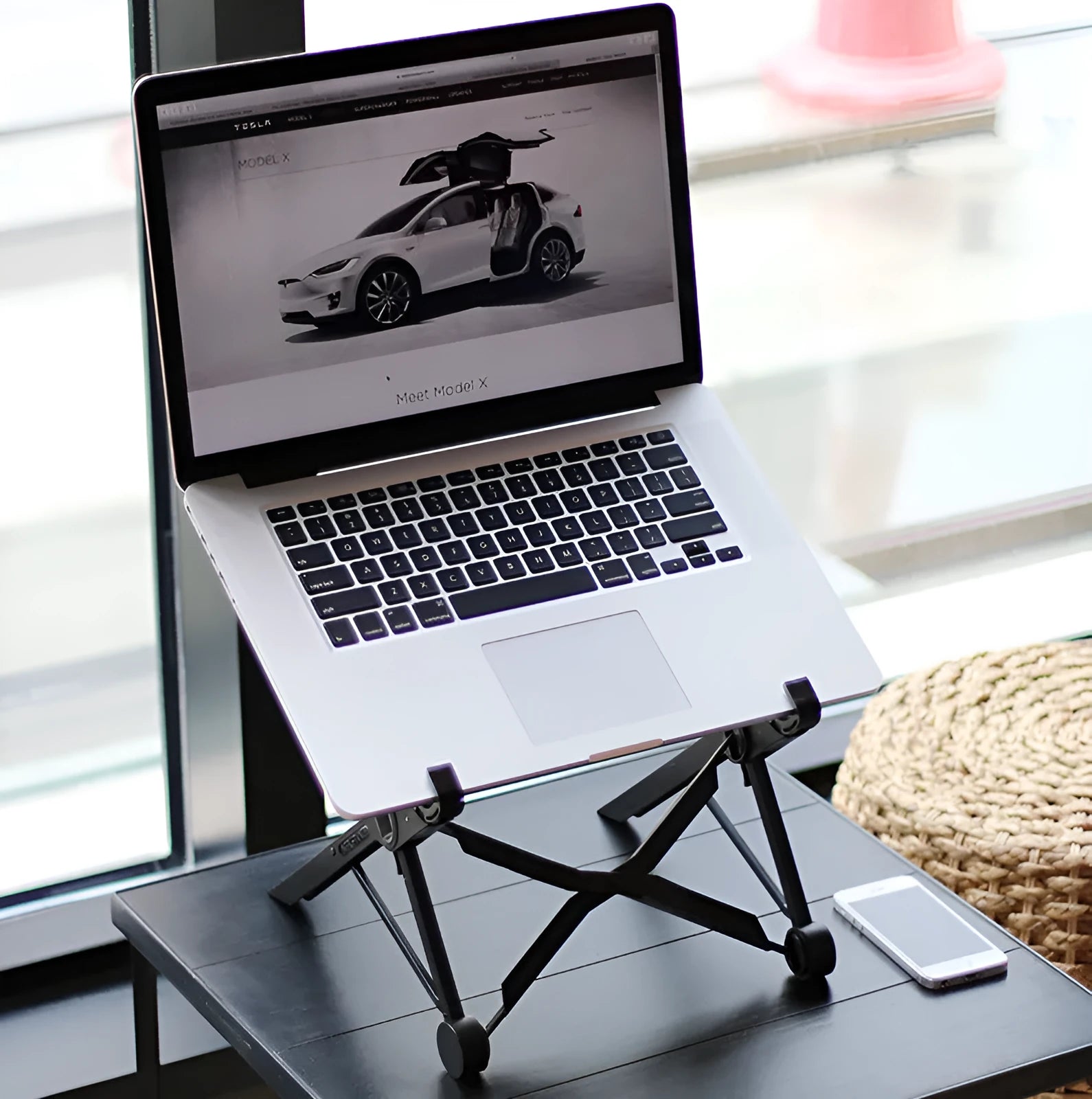Black folding laptop stand with reinforced nylon construction shown in open and folded positions