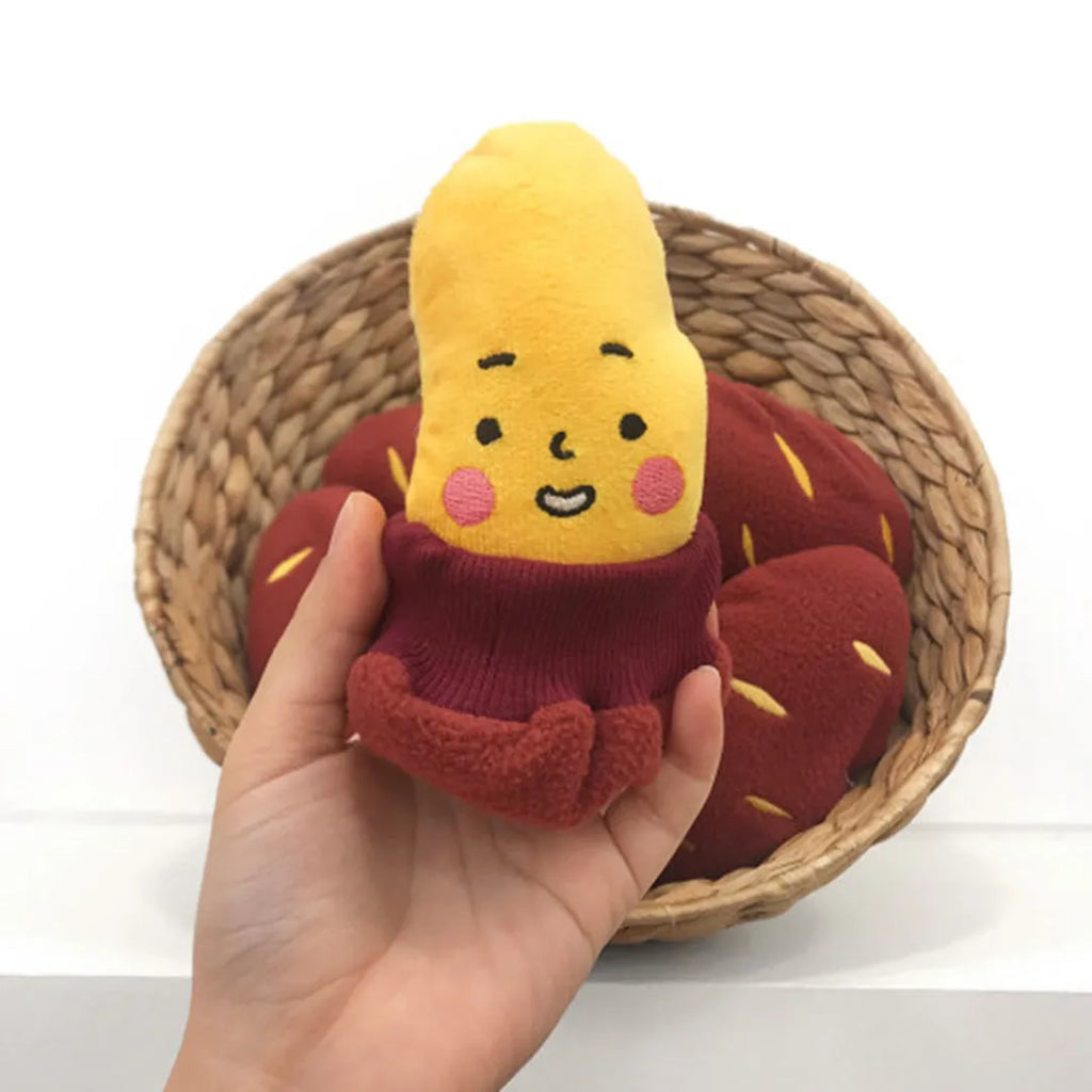 Red sweet potato-shaped dog toy with hidden food pockets and wrap-up design for treat puzzles.
