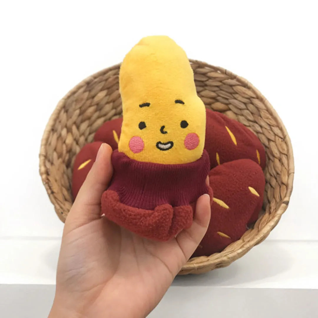 Red sweet potato-shaped dog toy with hidden food pockets and wrap-up design for treat puzzles.