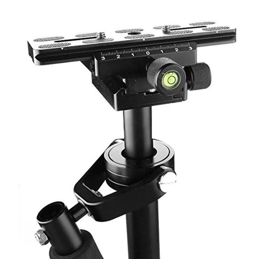 Black aluminium handheld camera stabilizer with adjustable height on a table.