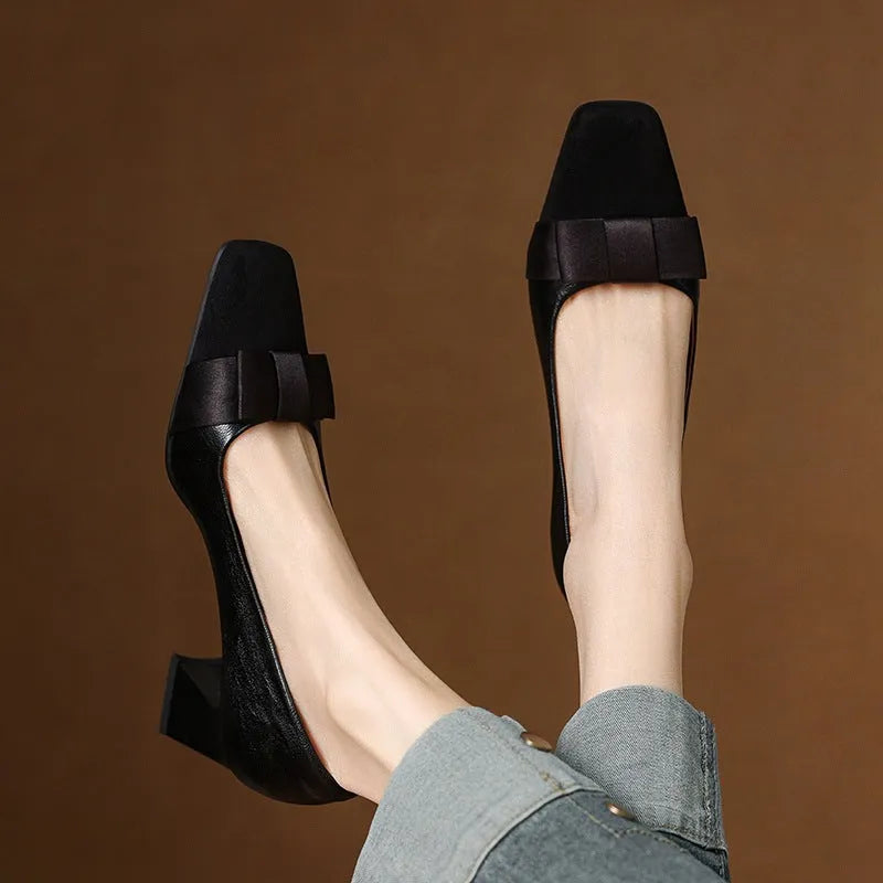 Retro square toe chunky heel pumps for women in black, with bow detail and low-cut design on a light background