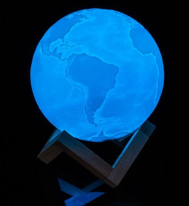 3D printed white moon lamp with textured surface on a wooden stand, showing touch ring at base