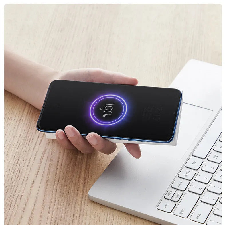 Black and white large capacity 10000mAh power bank showing USB-C port and wireless charging symbol.