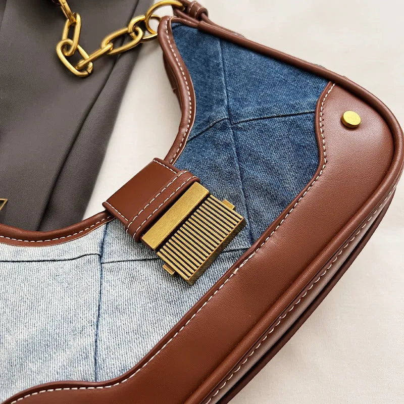Brown soft denim women's shoulder bag with diamond mesh and chain details, showing bucket shape.