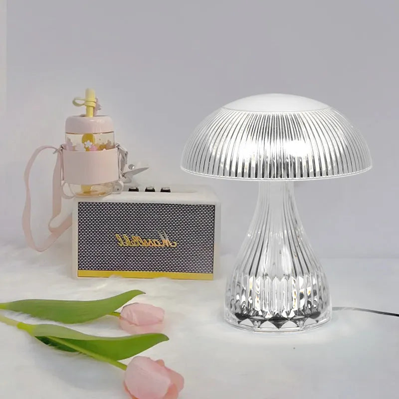Small white rechargeable night lamp with USB port and colour-changing LED light on a table.