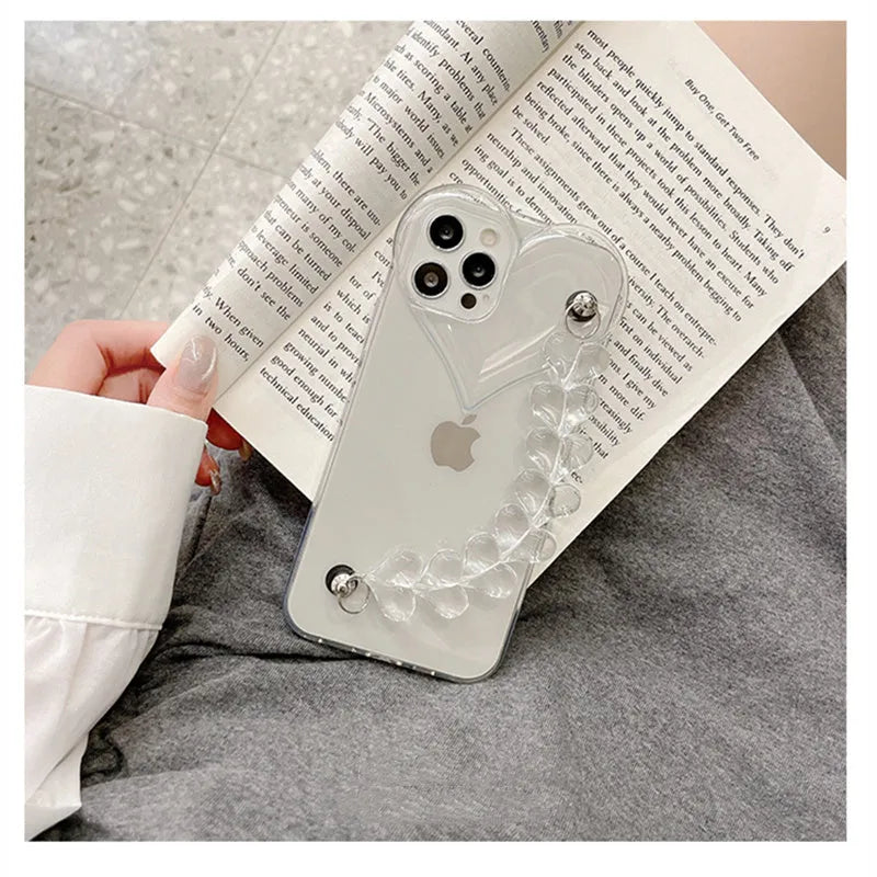 Transparent iPhone case with a love heart and bracelet chain design on a soft TPU background.
