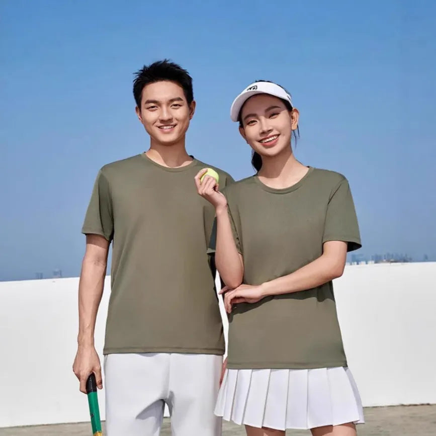 Men's loose fit solid colour polyester sports t-shirt on a hanger, showing short sleeves and casual cut.