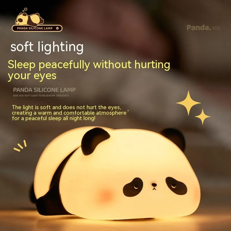 Cartoon panda silicone night light with USB charging cable on wooden surface