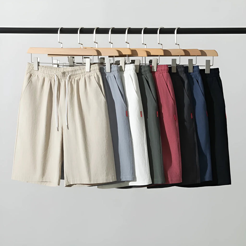 Man wearing loose-fit cotton linen cropped trousers in army green with a drawstring waist.