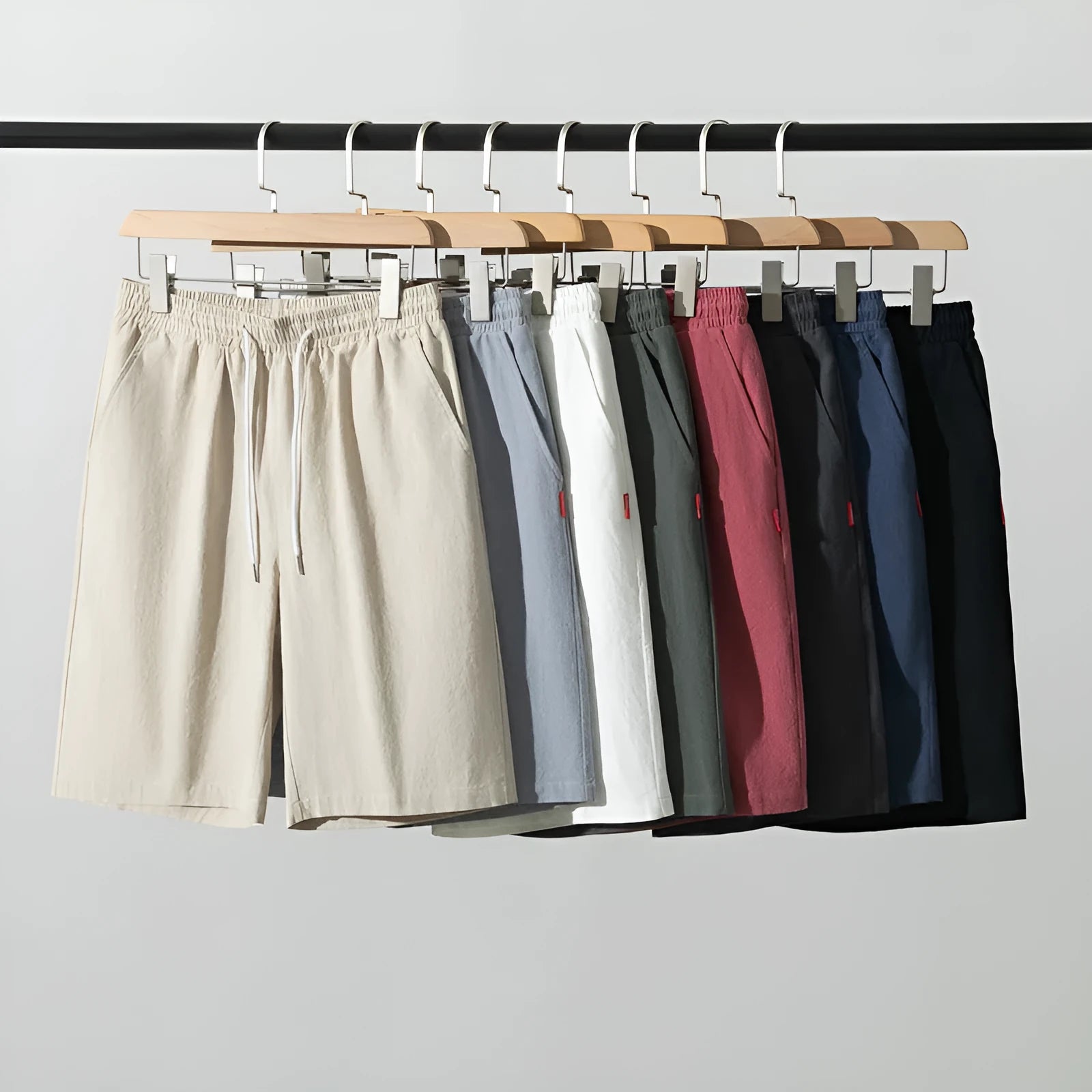 Man wearing loose-fit cotton linen cropped trousers in army green with a drawstring waist.