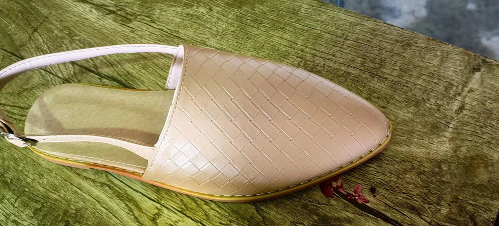 Black baotou flat sandals with a pointed toe and silver buckle closure on a rubber sole.