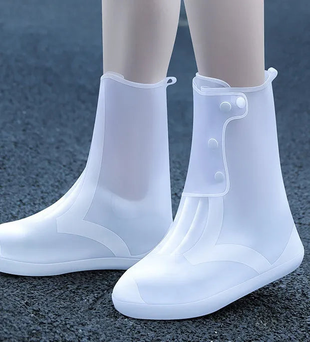 White high top PVC reusable water resistant shoe covers for women with anti-skid soles.