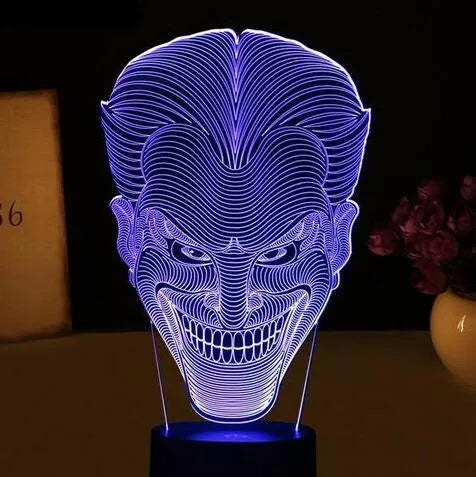 A modern 3D LED table lamp with a colourful gradient display, sitting on a square base with a USB cable.