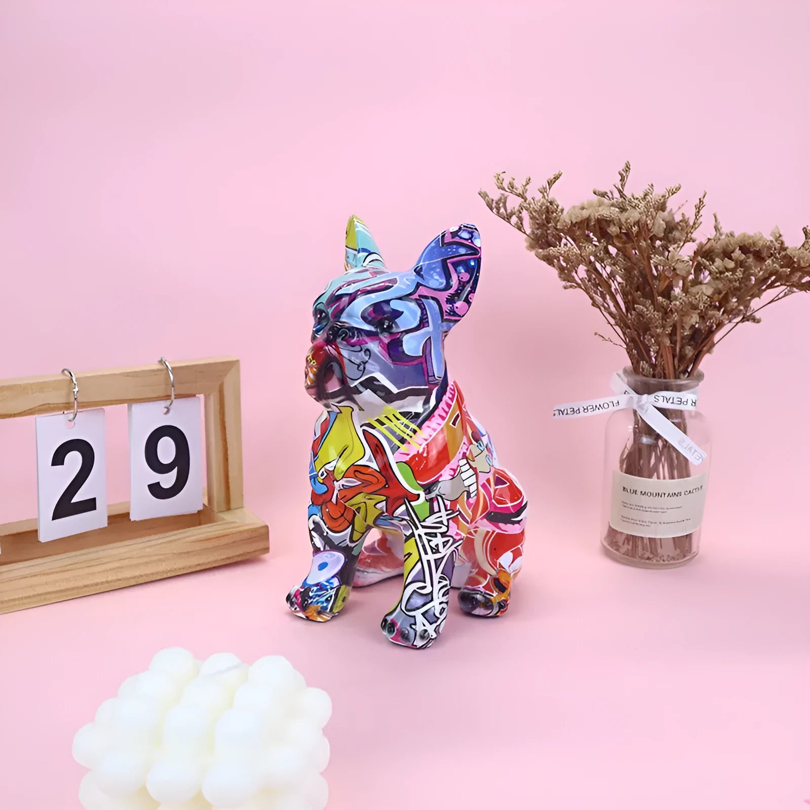 Graffiti-coloured resin French bulldog statue on a shelf