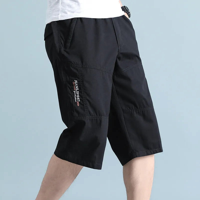 Men's straight-leg cotton sports pants in light grey showing cropped length and casual styling