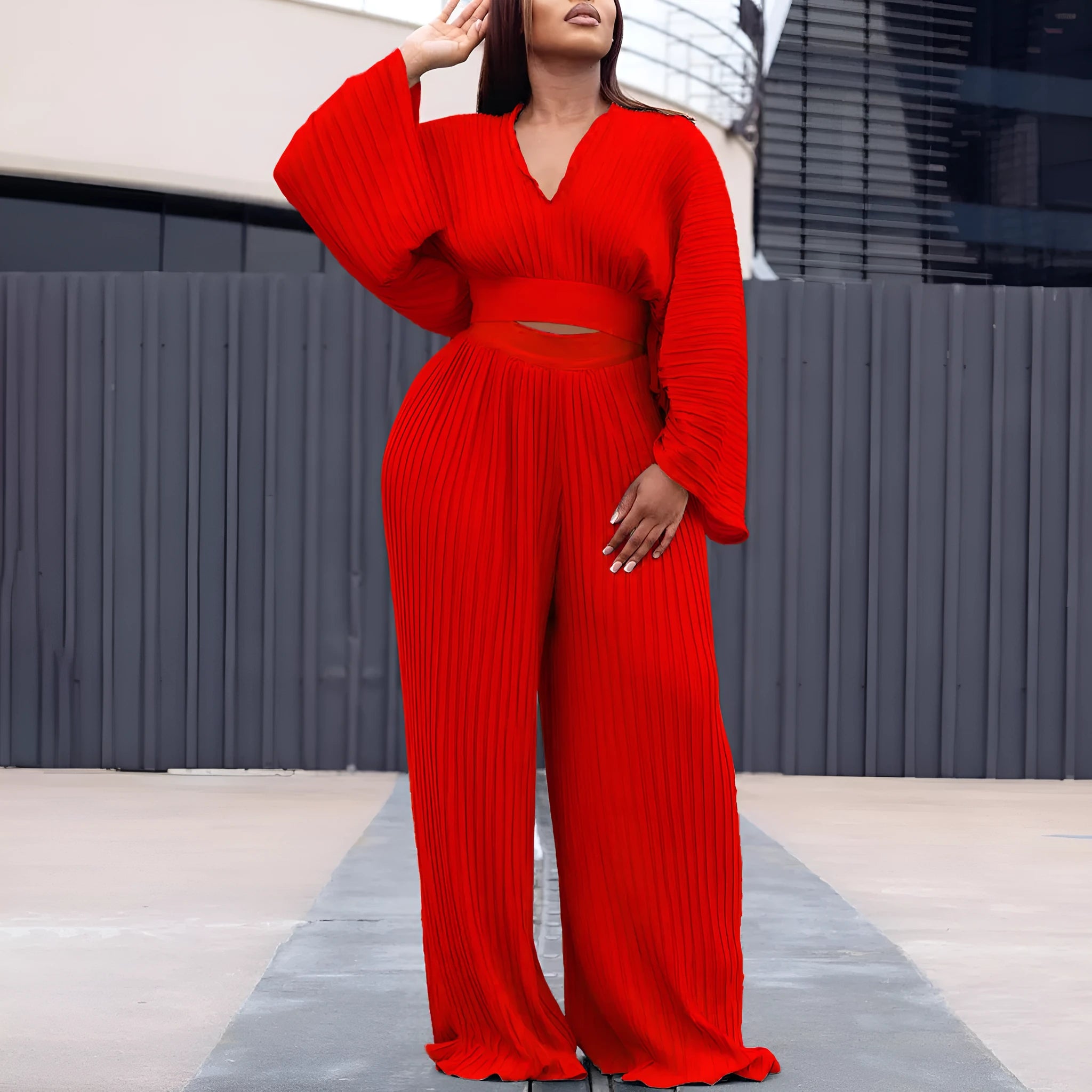Women's African print two-piece suit set with batwing sleeve blouse and wide leg trousers in red.