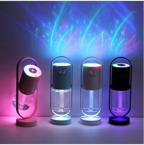 Pink Magic Shadow USB air humidifier with projection night lights on a wooden table.