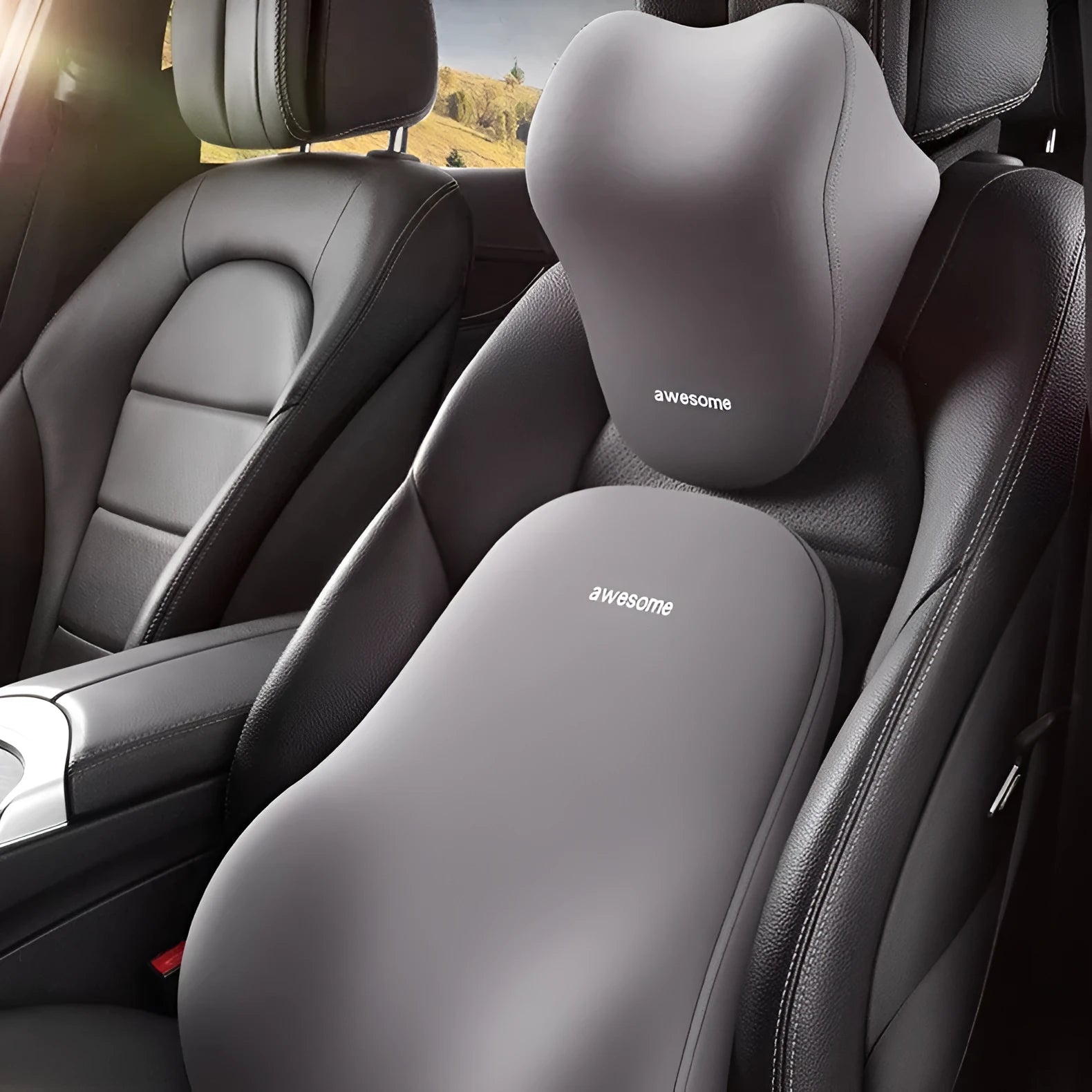 Black and beige memory foam car headrest pillow and lumbar support cushion on a vehicle seat.