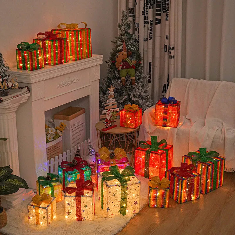 Set of three pre-lit Christmas gift box decorations with fabric bows and LED lights