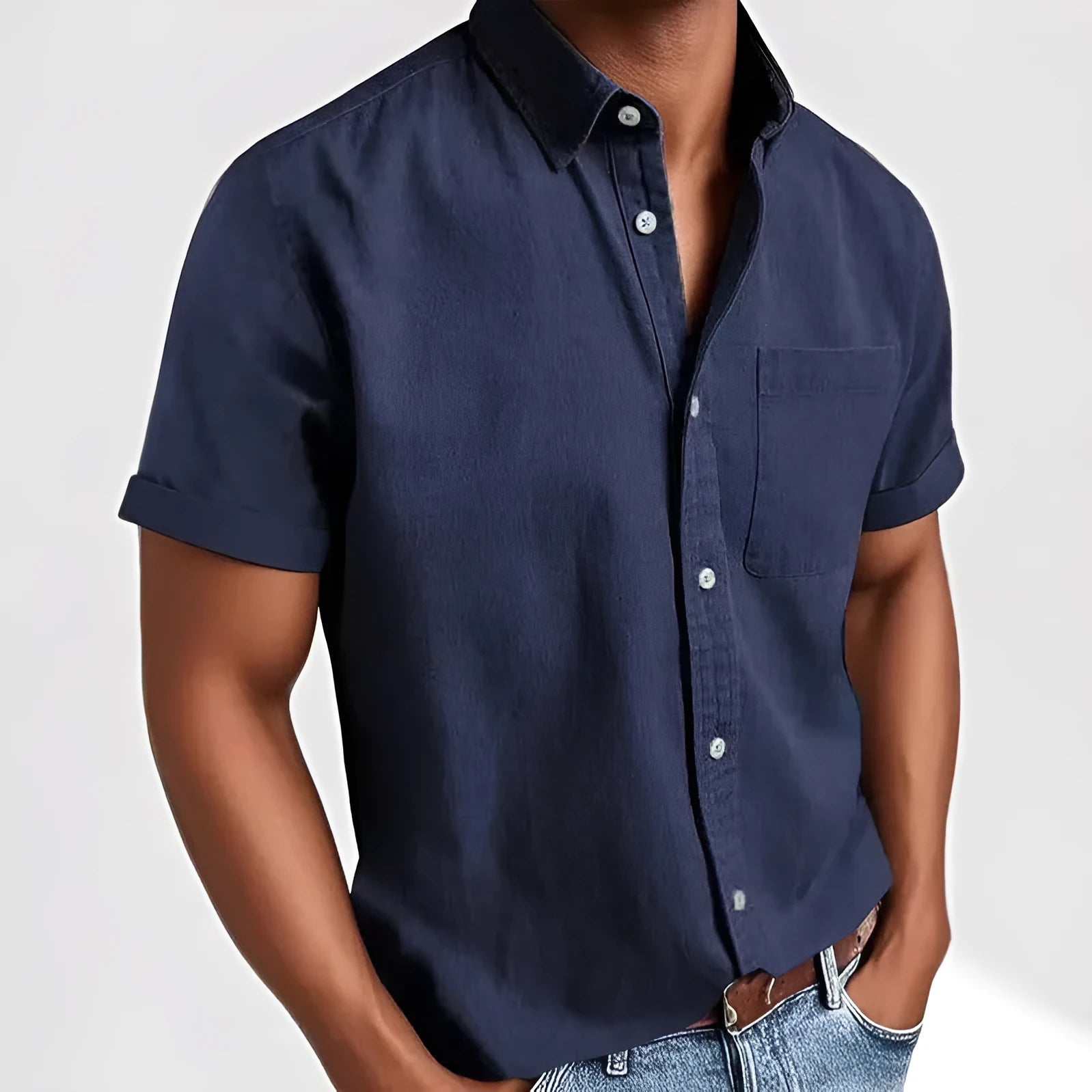 Man wearing a loose-fit grey short sleeve casual shirt with a single-breasted, cardigan-style design.