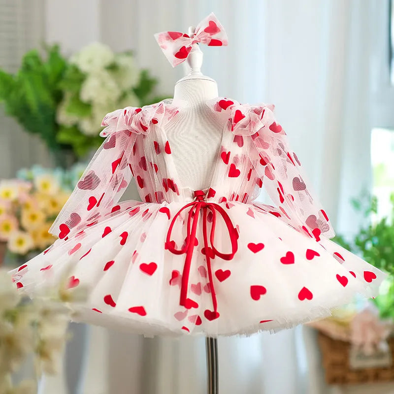 Children red love princess dress gown with heart print on light background, front view