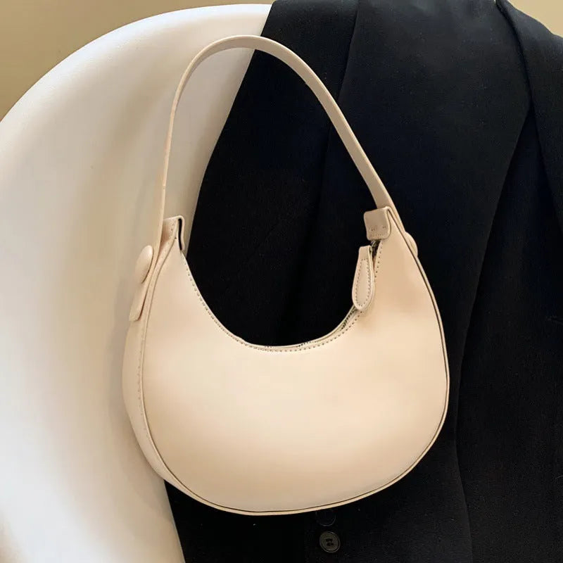 Retro dumpling-shaped women's shoulder bag in PU leather, shown in cream yellow colour.