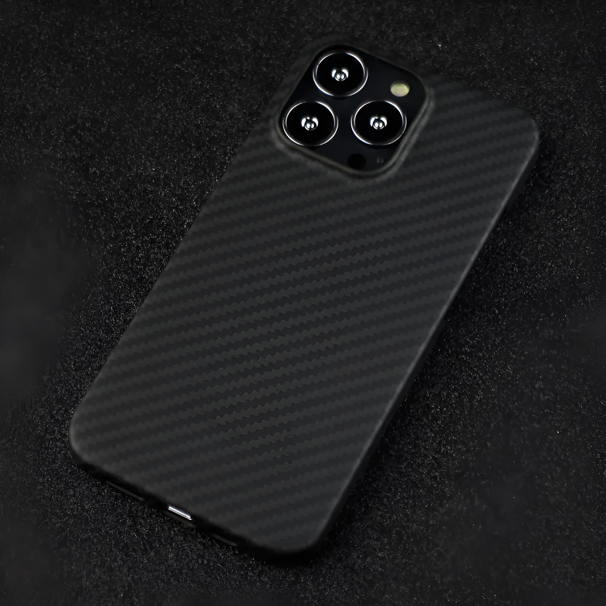 Matte black Kevlar fibre protective iPhone case showing textured surface and precise camera cutouts