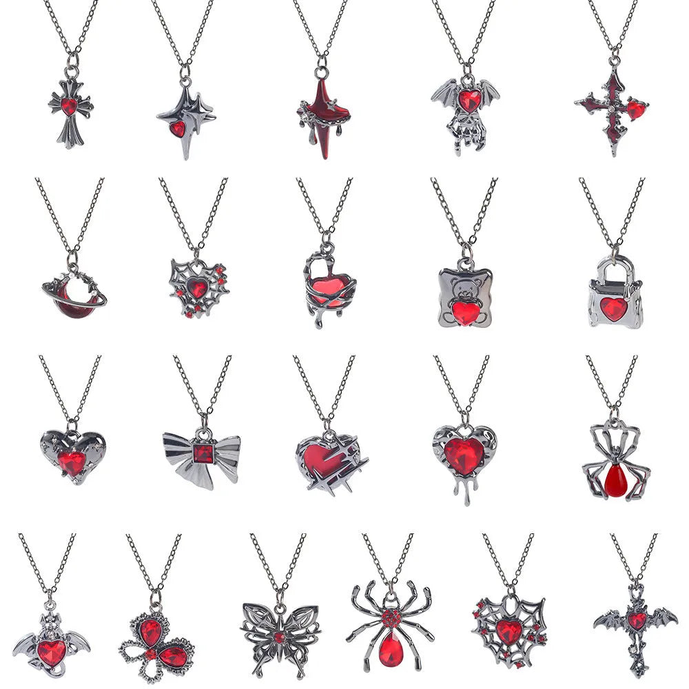 Halloween necklace with spider, bat, cross, and heart charm pendants on a metal chain.