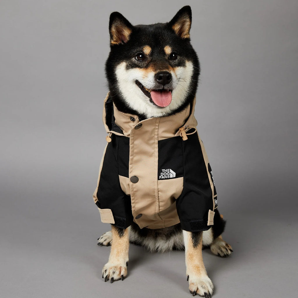 Khaki coloured polyester shell jacket for a dog on a white background.