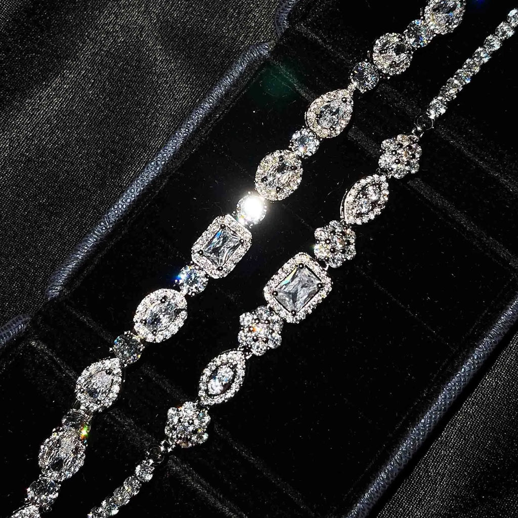 Close-up of women's geometric silver bracelet with sparkling cubic zirconia stones on a wrist, showing adjustable clasp.