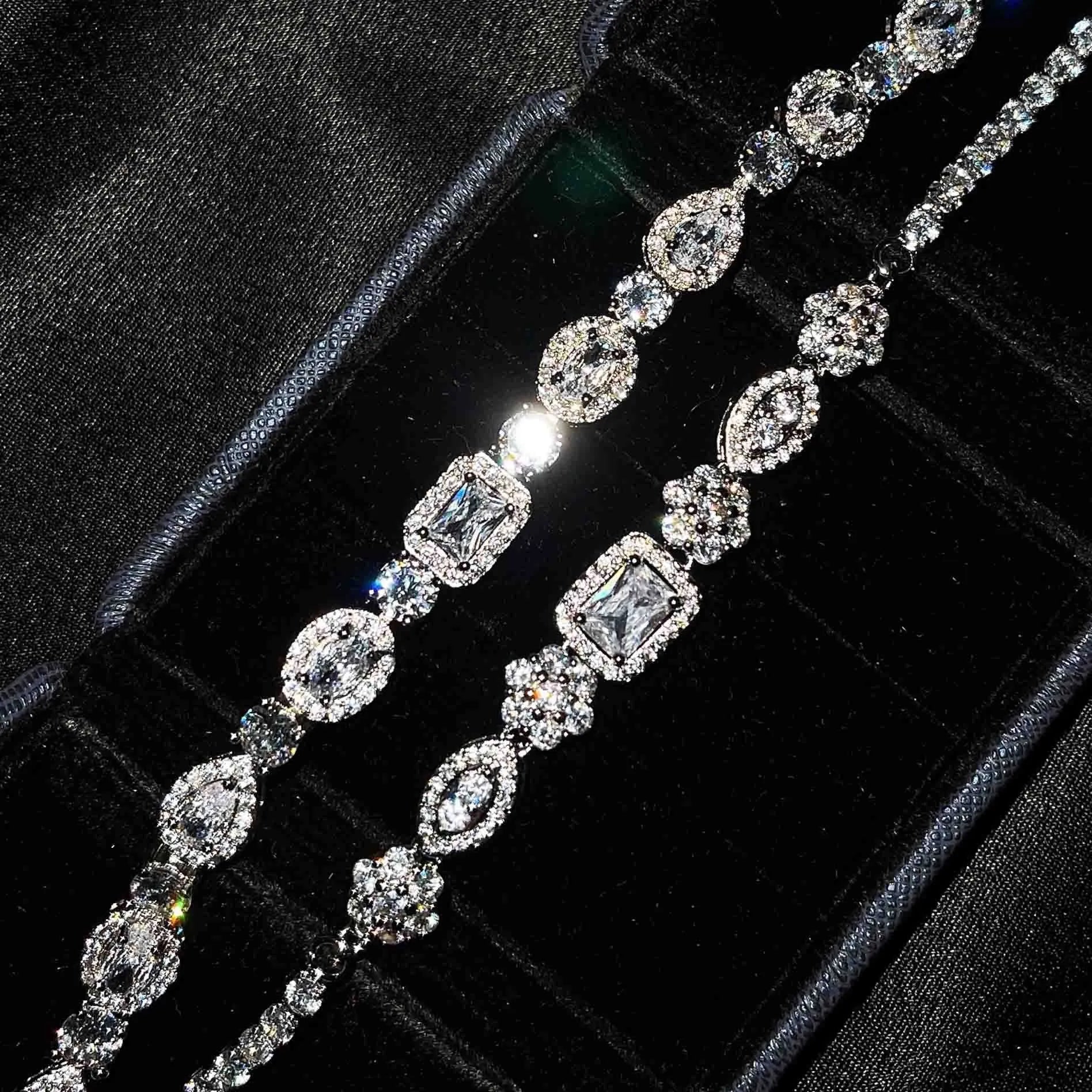 Close-up of women's geometric silver bracelet with sparkling cubic zirconia stones on a wrist, showing adjustable clasp.
