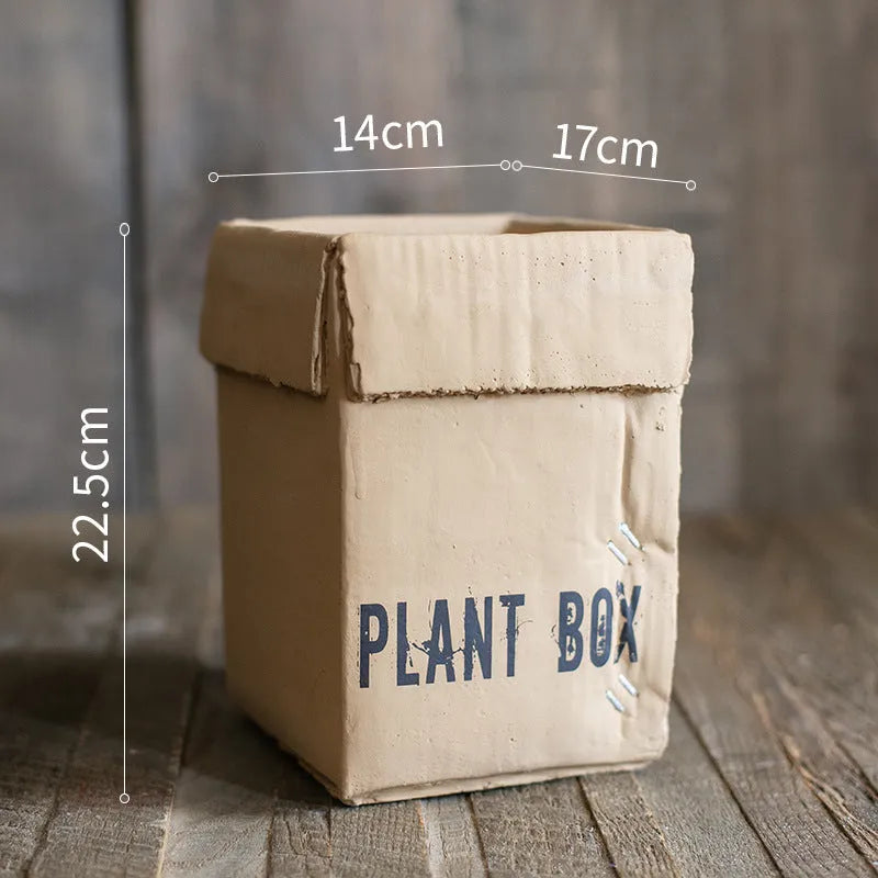 Cement flowerpot with brown paper box finish and drainage holes in bottom