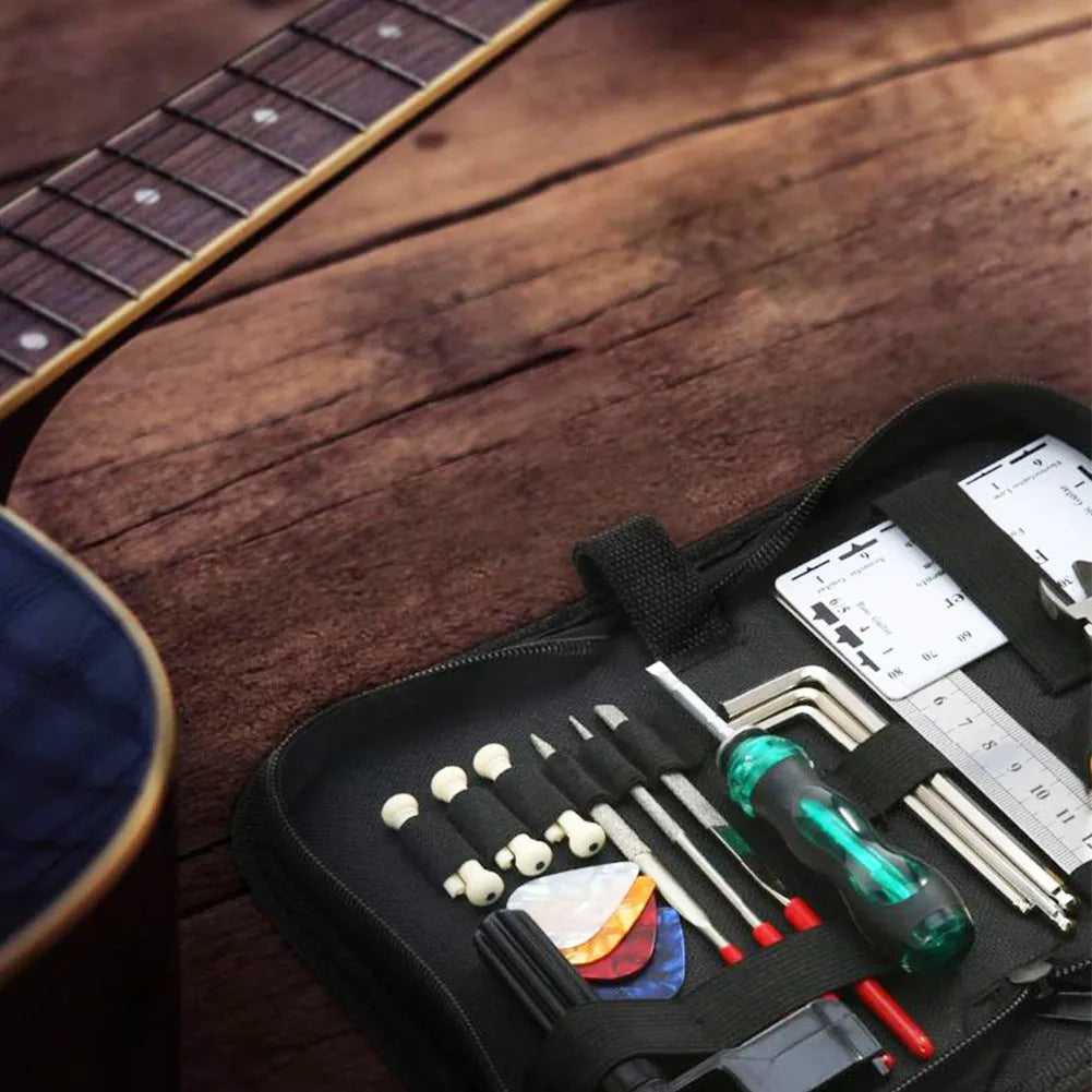 Open black guitar repair kit showing 12 metal tools including truss rod wrenches and a string winder in a zippered case.