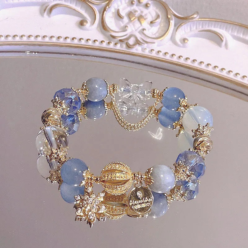 Galaxy-coloured women's bracelet with snowflake pendant, bow, and heart designs