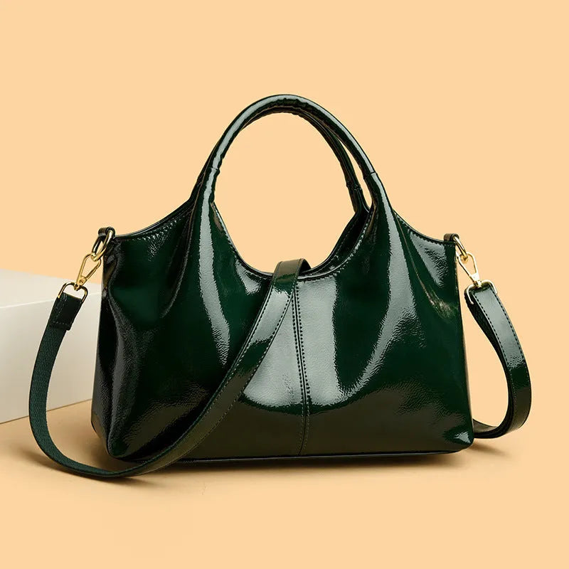 Genuine leather commuter bag with glossy finish, belt decoration, and leather grain in a horizontal square shape