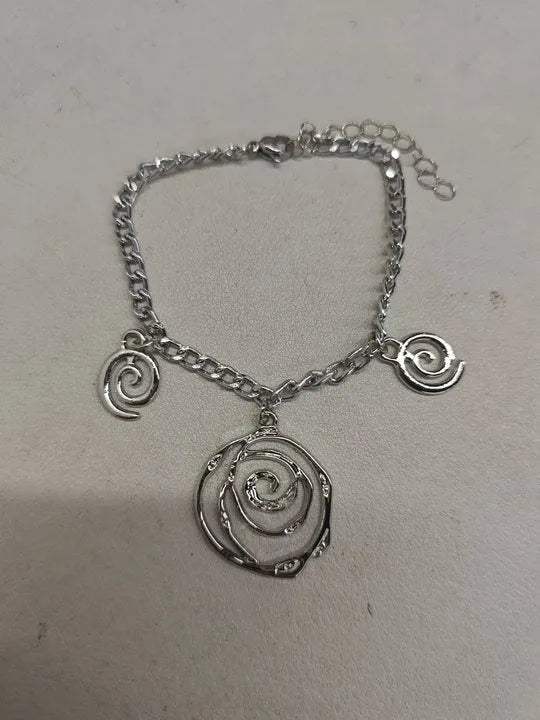 Spiral donut jewellery set showing necklace, bracelet and ear hooks with geometric circle designs in gold finish